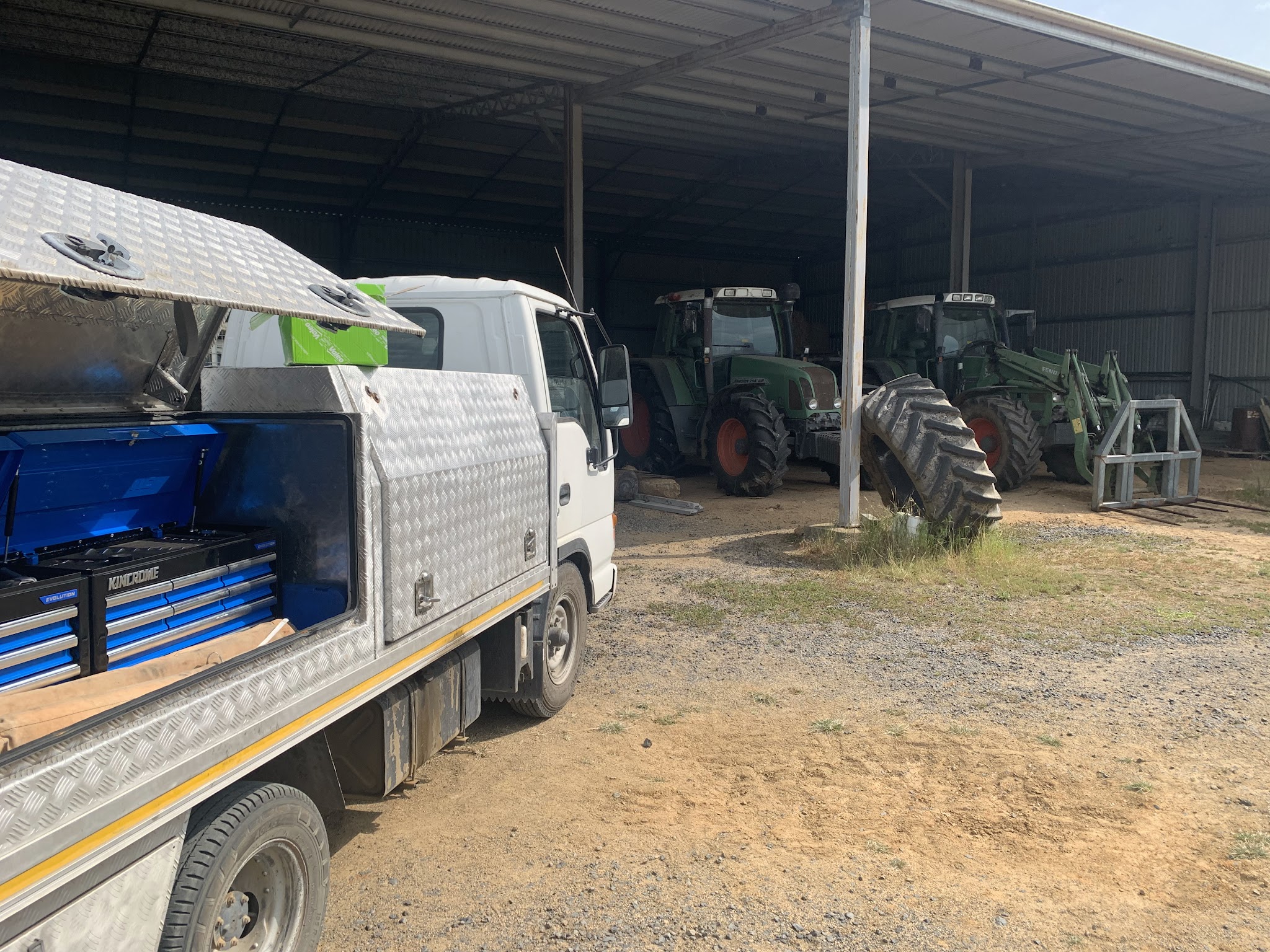The Sapphire Auto Electrics service truck with its tool chests, parked at a farm machinery shed