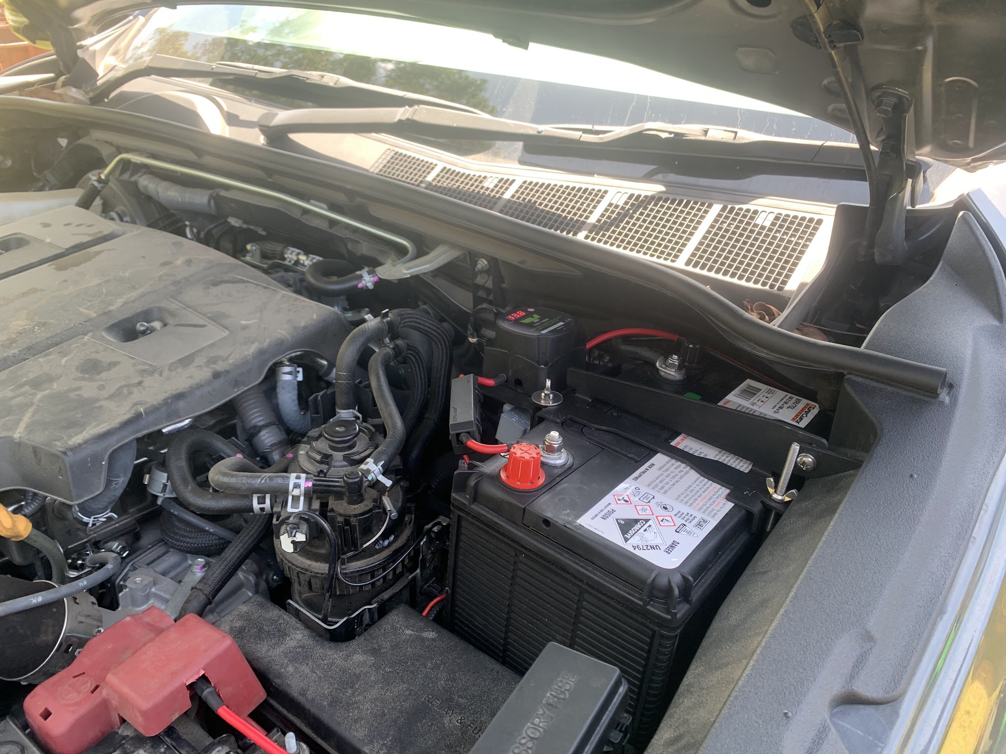 An engine bay with a second battery and a battery monitor fitted, part of a dual battery setup